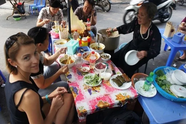 Street food stall in Hanoi with travelers