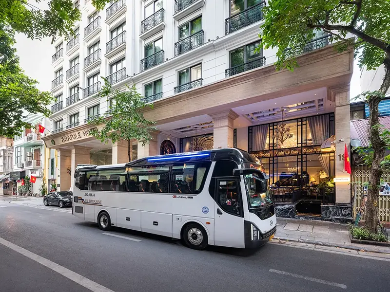 Tour limousine bus outside a Hanoi hotel, similar to CVT pickup vehicles